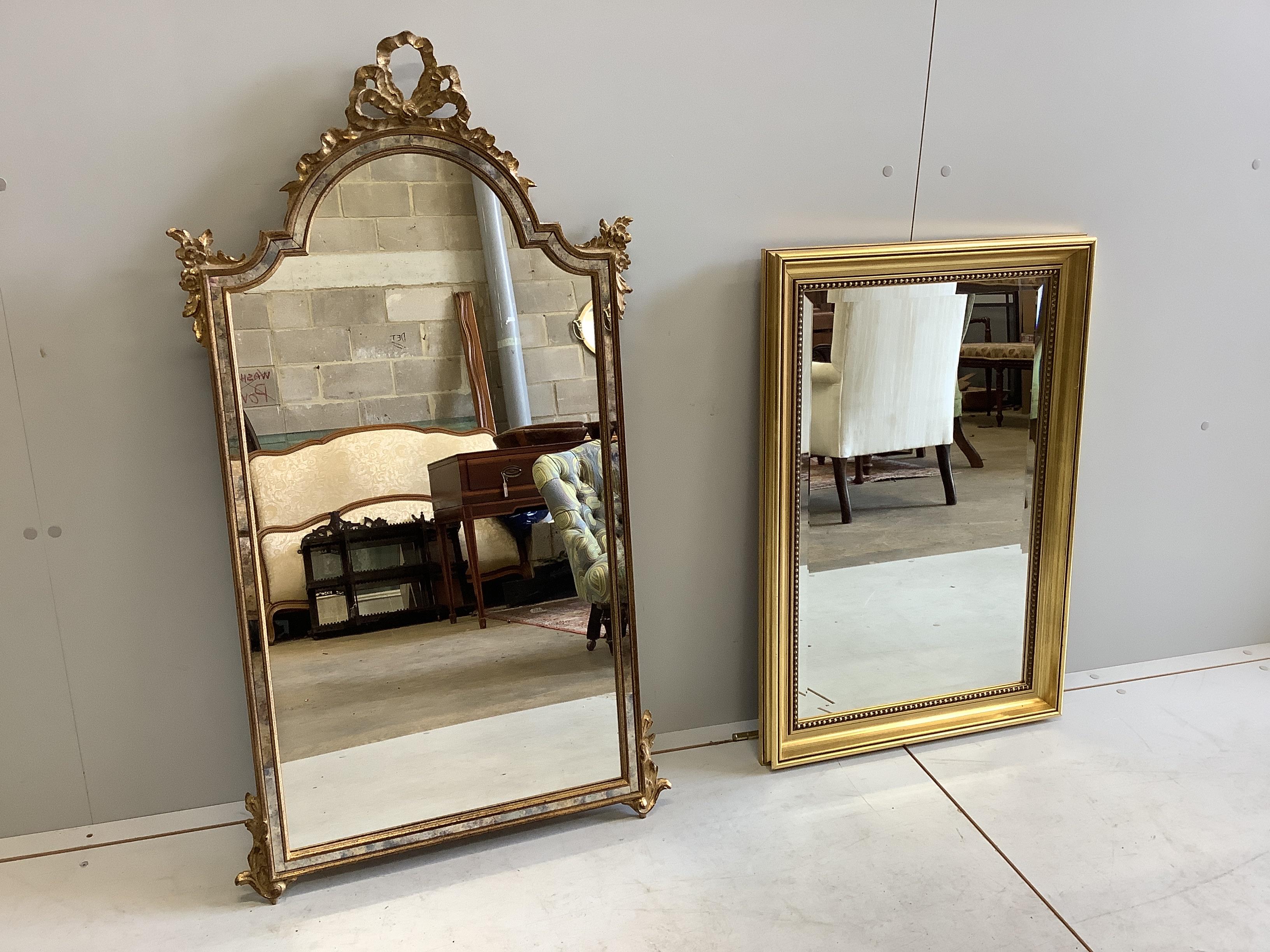 A reproduction giltwood and composition marginal plate wall mirror with ribbon crest, width 57cm, height 104cm, together with a smaller rectangular gilt composition wall mirror